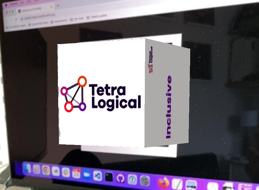 A cube with the TetraLogical logo on the front, augmented on top of a laptop screen